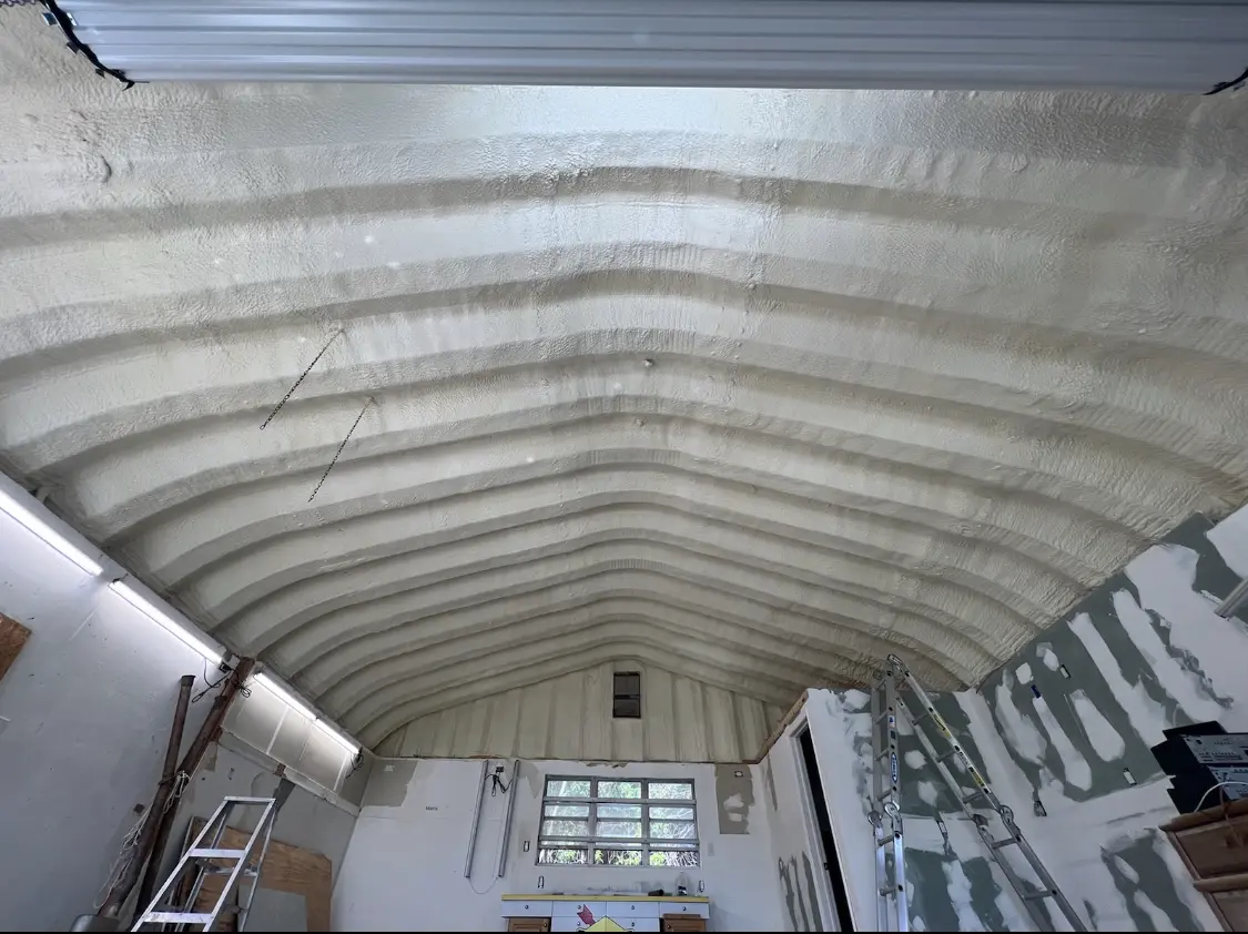 Spray polyurethane foam applied to the underside of a metal roof deck in Hugo